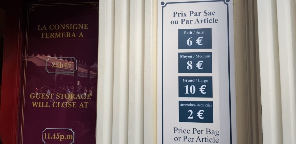 Sign with the former prices of Disneyland Paris Guest Storage (Consigne) from 2019, showing Small (€7), Medium (€9), and Large (€12) bag rates.