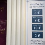 Sign with the former prices of Disneyland Paris Guest Storage (Consigne) from 2019, showing Small (€7), Medium (€9), and Large (€12) bag rates.