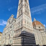 Florence Duomo Complex: Ground view from Piazza del Duomo showing the striped marble facade of Giotto's Bell Tower and the massive dome of Brunelleschi's Cupola.