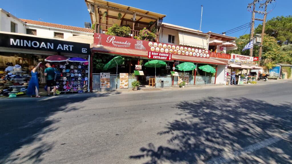 Shops, stalls, and commercial activities located immediately outside the Knossos Palace entrance area.