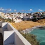 Is the Algarve Worth Visiting in Winter A Guide to 10 Stunning Beaches - Carvoeiro beach in the Algarve, Portugal, on a sunny winter day, with white buildings on the cliffs overlooking the beach.