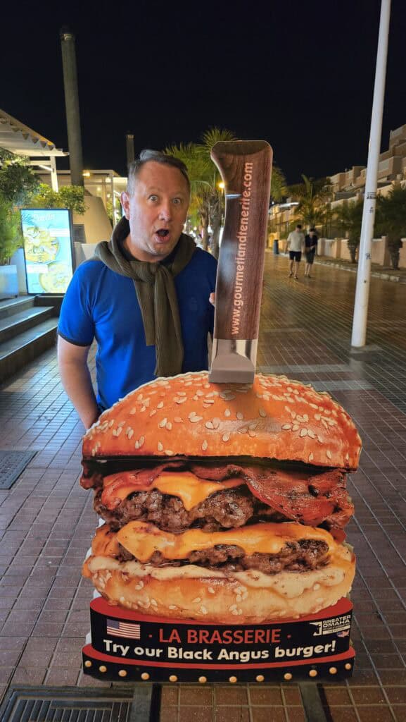 Tenerife Nightlife Expert Guide: How to Find Your Perfect Bar & The Canary Islands Vibe 2 Large, supersized hamburger and fries served on a plate in a Tenerife tourist restaurant.