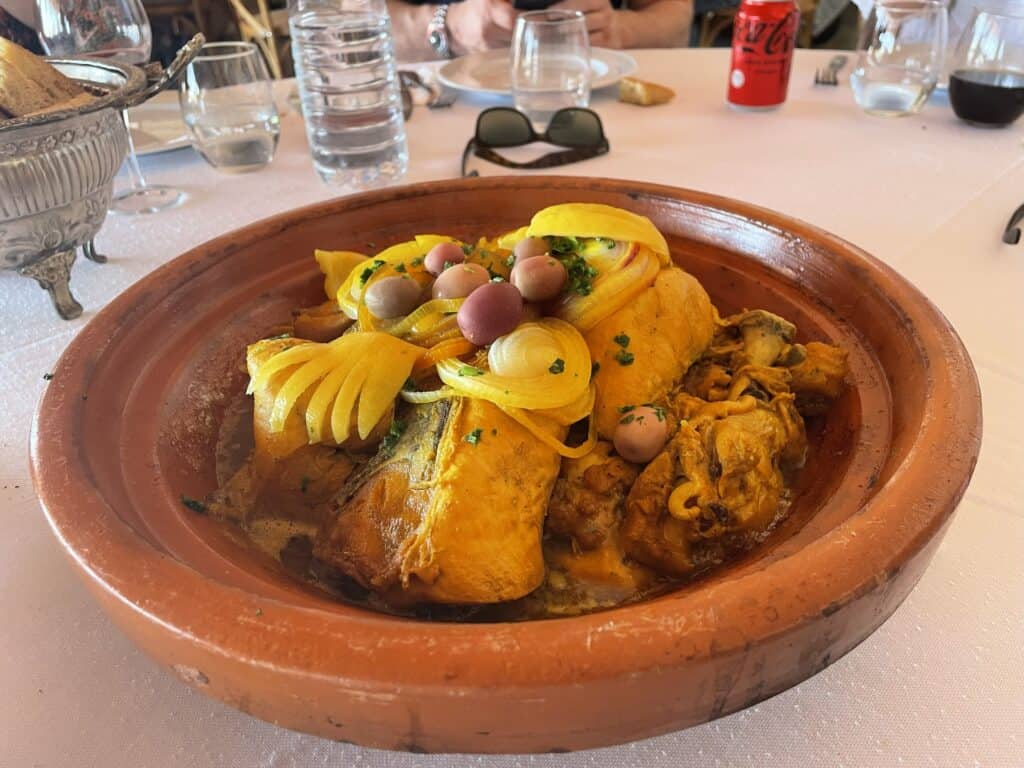 Marrakech Quad Biking: Thrills, Oasis Luxury & The City's Hidden Contrast 6 Delicious Moroccan Tagine dish with chicken, lemon, and olives served at the desert oasis resort lunch.