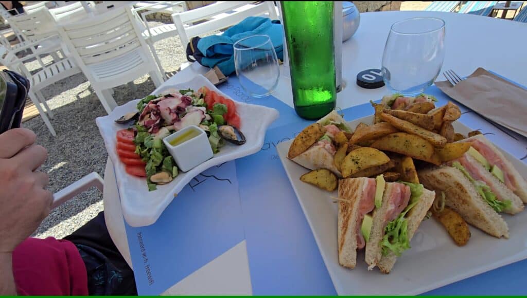 Salata me Thalassina (Seafood Salad) and Salmon Club Sandwich served at Cavo Psarou, Psarou Beach, Mykonos.