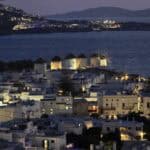 Mykonos Town comes alive at night, with its twinkling lights and famous windmills creating a sparkling, enchanting skyline.
