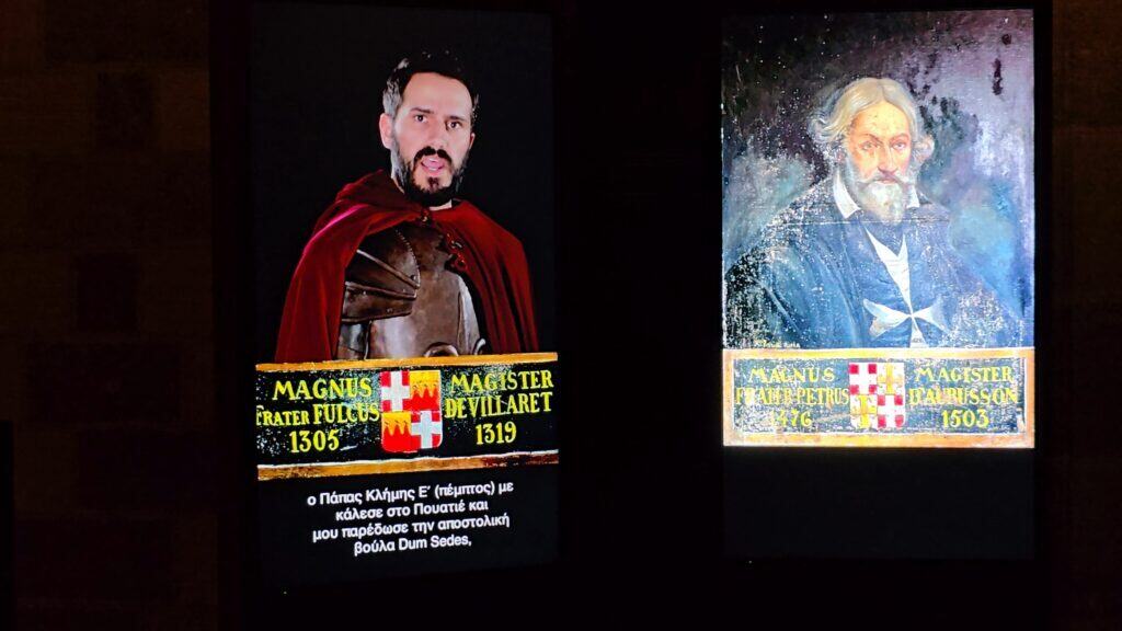 Close-up of a historical projection in the Grand Master's Palace showing a Knight, with the spoken audio in English and subtitles clearly visible in Greek.
