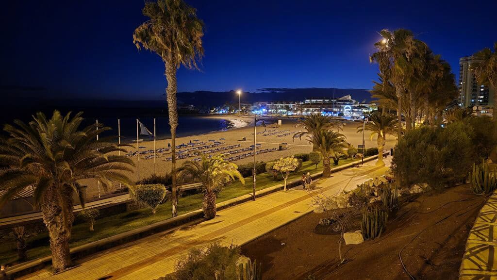 Paseo Marítimo Los Cristianos nightlife atmosphere at night, Tenerife South promenade.