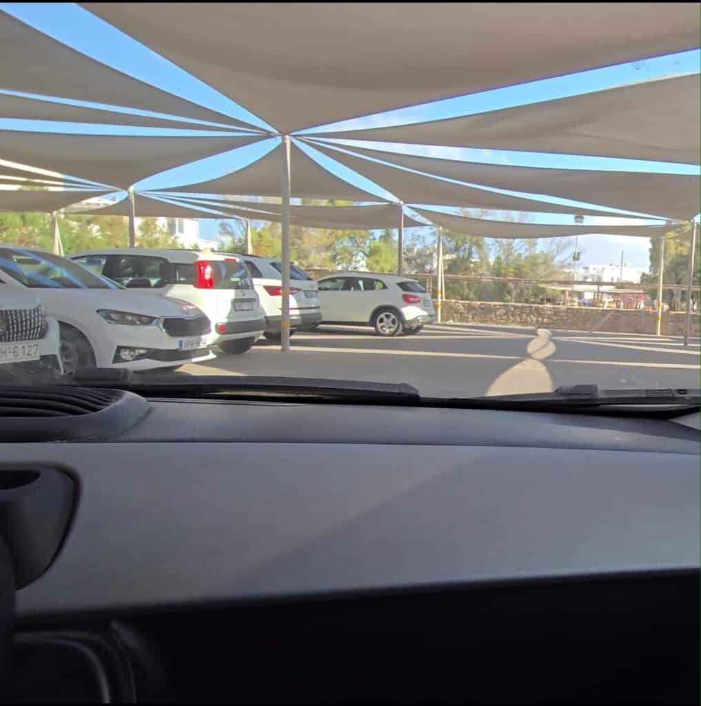 Covered Valet Parking Area near Ornos Beach Mykonos, showing cars protected from the sun.