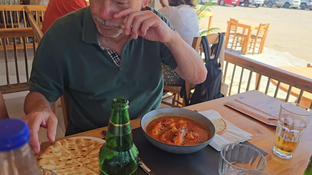 Enjoying lunch with Mythos beer and Gamberi Saganaki at Oasis Taverna, Prasonisi Beach.