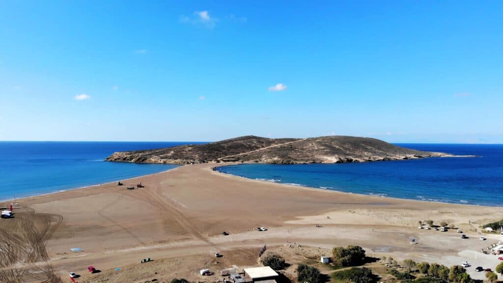 Close-up view showing the visual separation where the rough Aegean Sea meets the calm Mediterranean Sea at the Prasonisi isthmus.