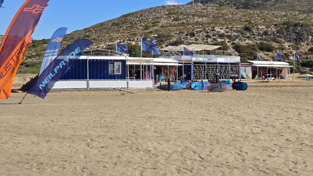 Prasonisi Rhodes: Where Two Seas Meet (2026 Planning Guide & Prices) 8 Prasonisi windsurfing and kitesurfing equipment rental area. Shows gear availability and school setup on the Aegean side.