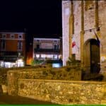 Illuminated entrance and closed gate of the Scaliger Castle in Sirmione at night