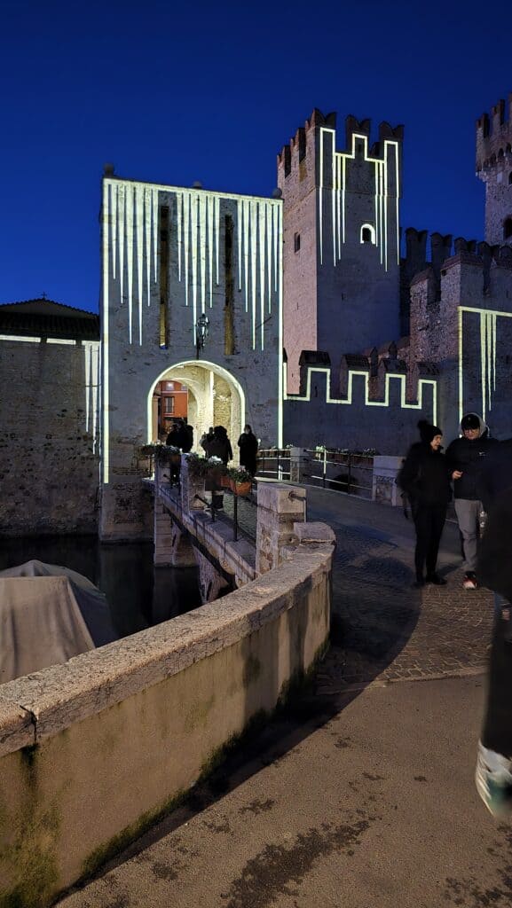 Scaliger Castle of Sirmione illuminated by dynamic light projections in winter (Roots Tourism theme)