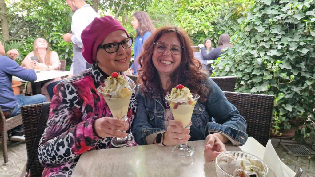 Ila and friend enjoying a huge Bandirali gelato super-cup in Crema, Italy, near the city center