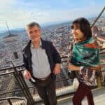 Spontaneous photo of two mature travelers on the Brunelleschi's Dome balcony, smiling and enjoying the Florence panorama, demonstrating the climb's feasibility for active older visitors.