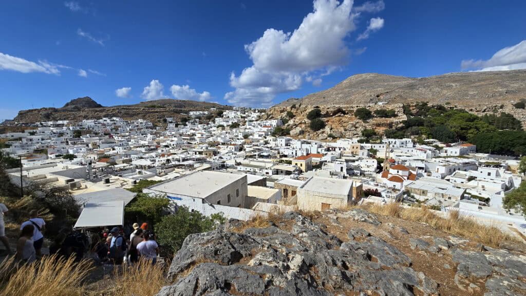 Capturing the 'White Dream' of Greece: The breathtaking view of Lindos village and its dazzling white houses, seen while descending from the Acropolis. This perspective brings the map's layout directly into reality.