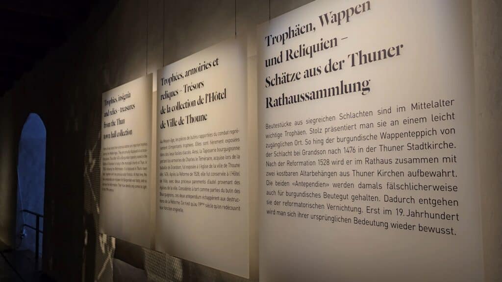 Informational displays inside Thun Castle written in English, French, and German, highlighting the museum's accessibility for international tourists as noted by Ila from Tripilare.