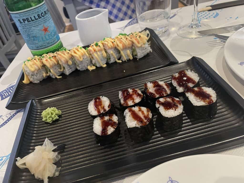 Two plates of sushi at Deep Blue Mykonos, showing the portion size for a 16€ shrimp roll and a 15€ spicy tuna roll.