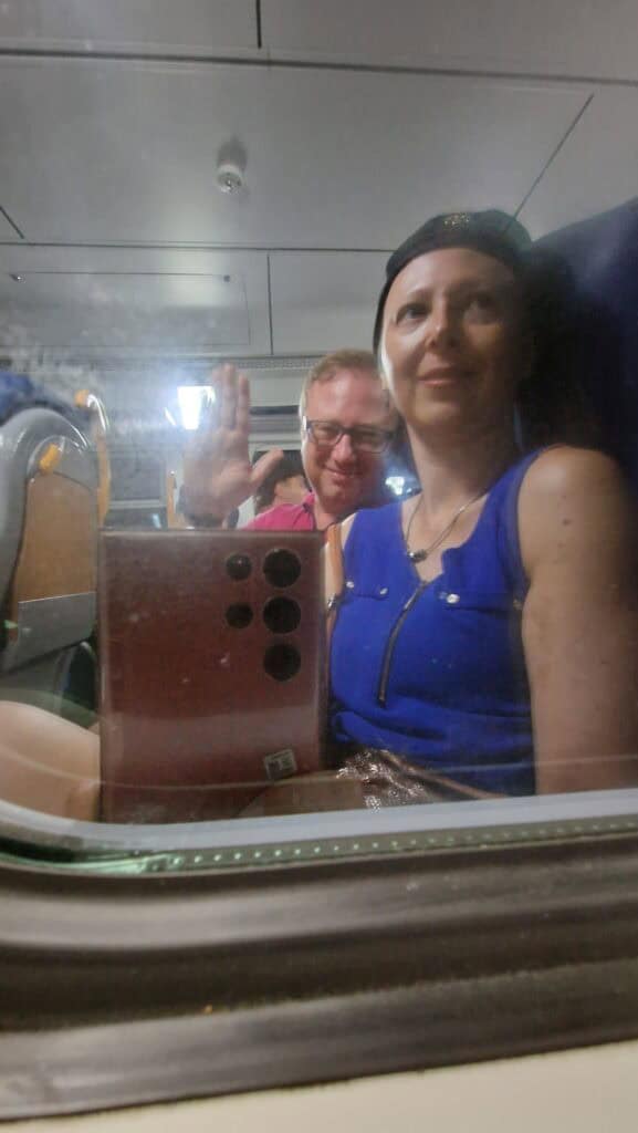 Vernazza Italy: A Gem of the Cinque Terre 13 Ila and Gabriel sitting on the train at night, returning from Vernazza to Monterosso, with their reflections visible in the window glass.