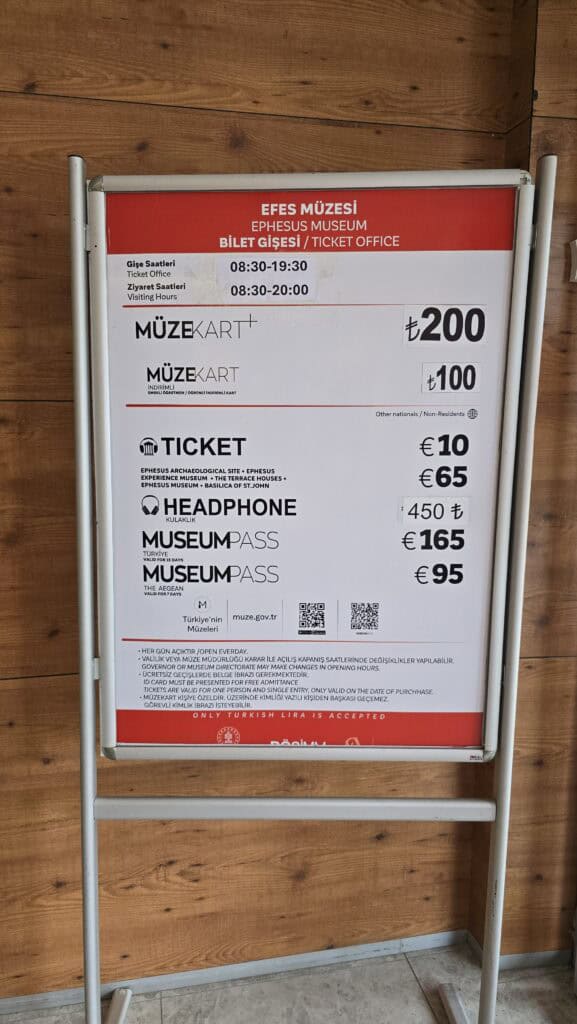 Official price board at the Ephesus Museum ticket office in Turkey, listing costs for combined tickets, museum passes, and headphones in May 2026.