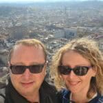 Ila and Gabriel taking a perfect selfie on the open balcony of Brunelleschi's Dome, showing the iconic Florence cityscape and the Giotto Bell Tower in the background.