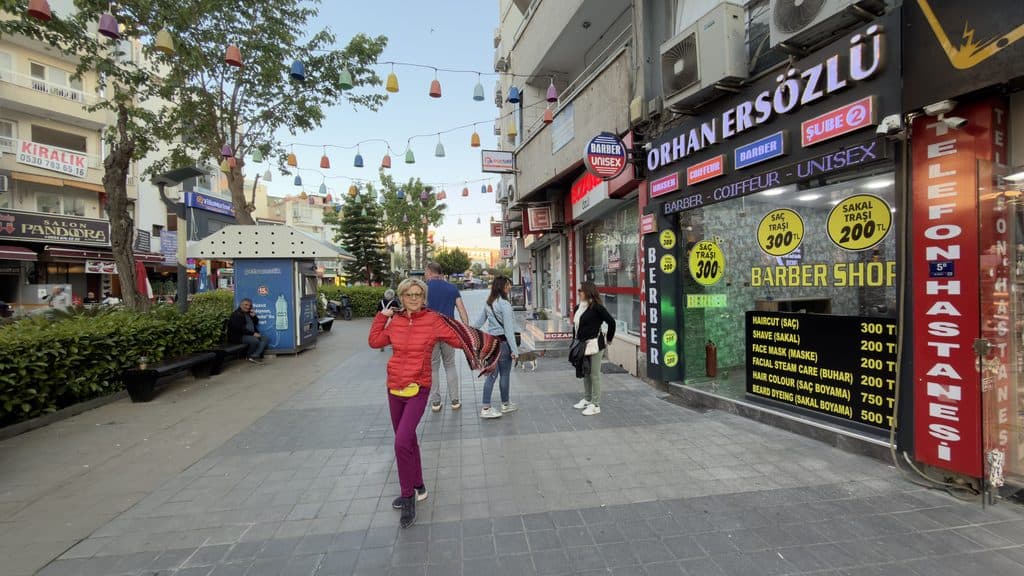 Ila, author of tripilare.com, walking with friends from the promenade toward the main shopping street in Kusadasi in May.