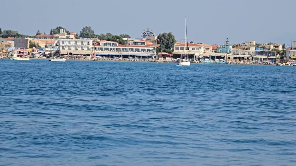Laganas, Zakynthos: The Honest Truth – Beyond the Tourist Hype 1 View of the highly urbanized beach front of Laganas, Zakynthos, from the sea, showing dense hotel and restaurant development.