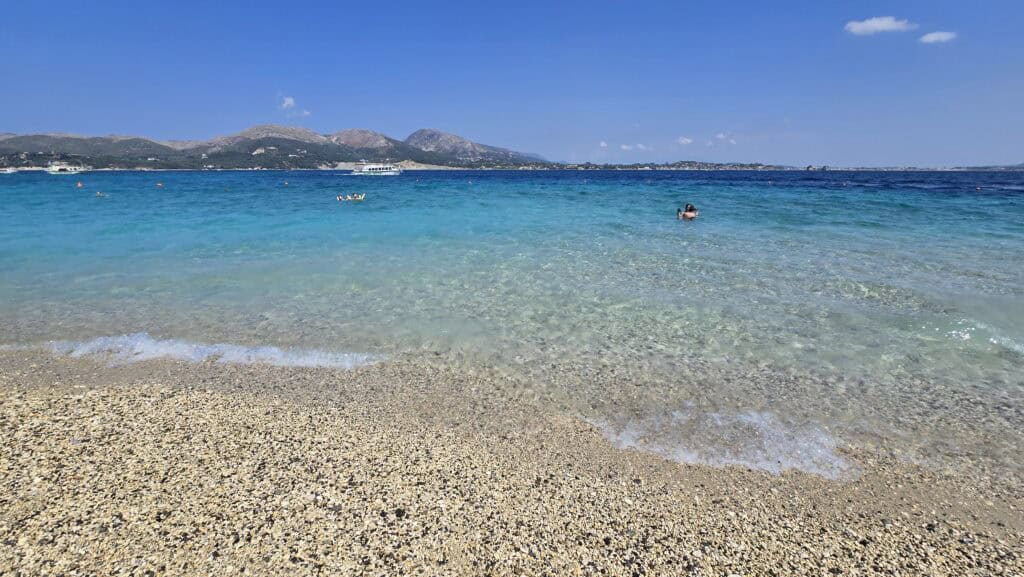 Laganas, Zakynthos: The Honest Truth – Beyond the Tourist Hype 2 Crystal clear turquoise water at the pebble beach of Marathonisi, also known as Turtle Island in Zakynthos, Greece.